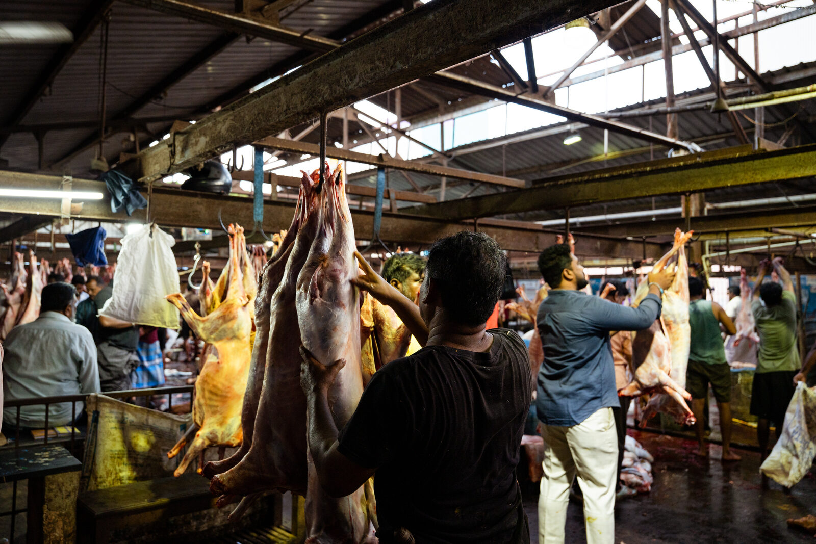 Labourers in the goat slaughter units at the Puliyanthope slaughterhouse.