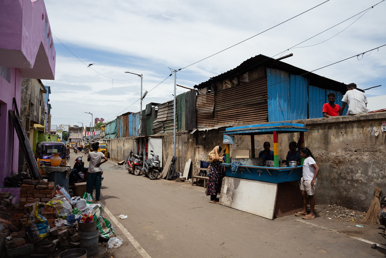 Homes behind the slaughterhouse's temporary sheds where cattle bones are left to dry for months, emitting a foul odour.